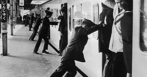 २) लोकांना रेल्वेत ढकलणारा